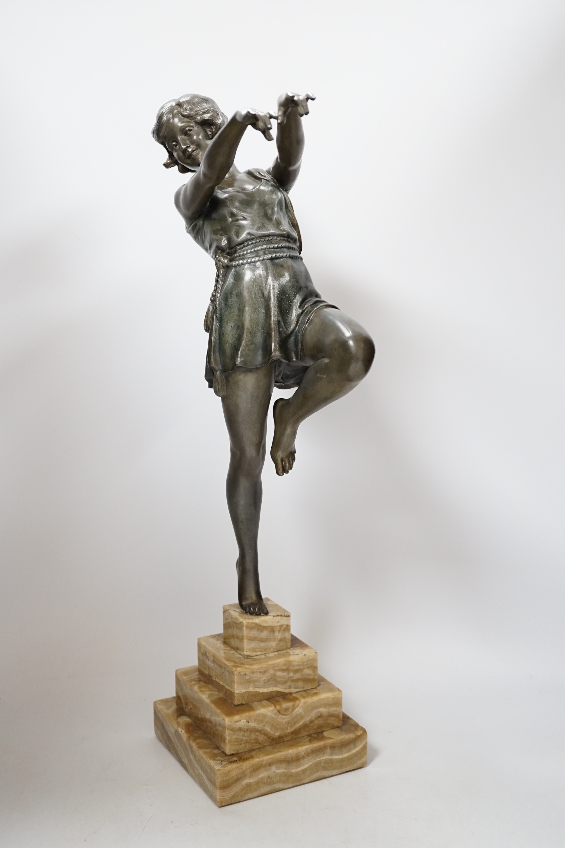 A spelter Art Deco figure of a woman, signed Carlier, on a stepped marble base, 52.5cm